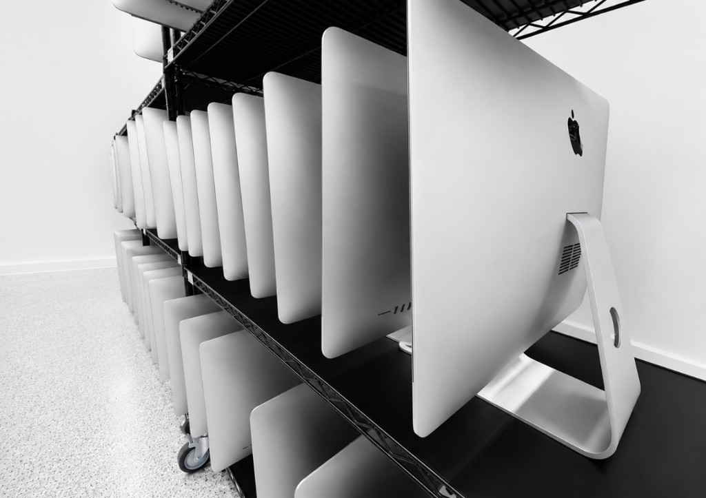 Rows of iMac computers staged on warehouse racks